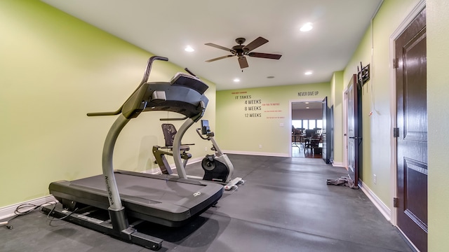 workout room with a fireplace and ceiling fan