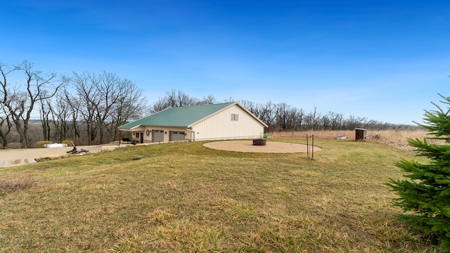 view of front of property featuring a rural view, a front lawn, and a garage