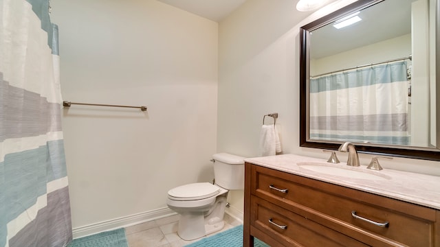 bathroom featuring tile floors, toilet, and large vanity