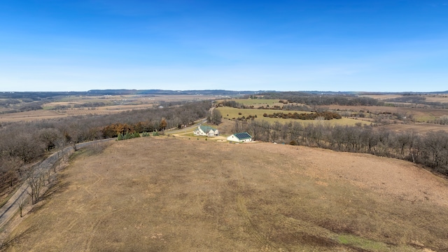 birds eye view of property with a rural view