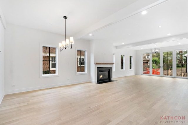 unfurnished living room featuring beamed ceiling, a notable chandelier, and light hardwood / wood-style floors