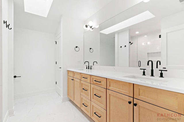 bathroom featuring a skylight, tile floors, and double vanity