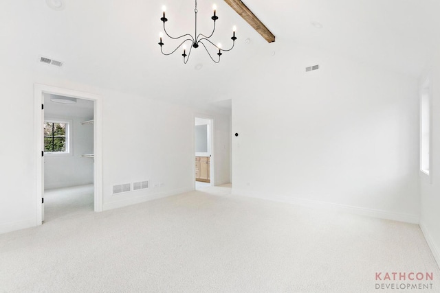 unfurnished room featuring light carpet, beamed ceiling, and a notable chandelier