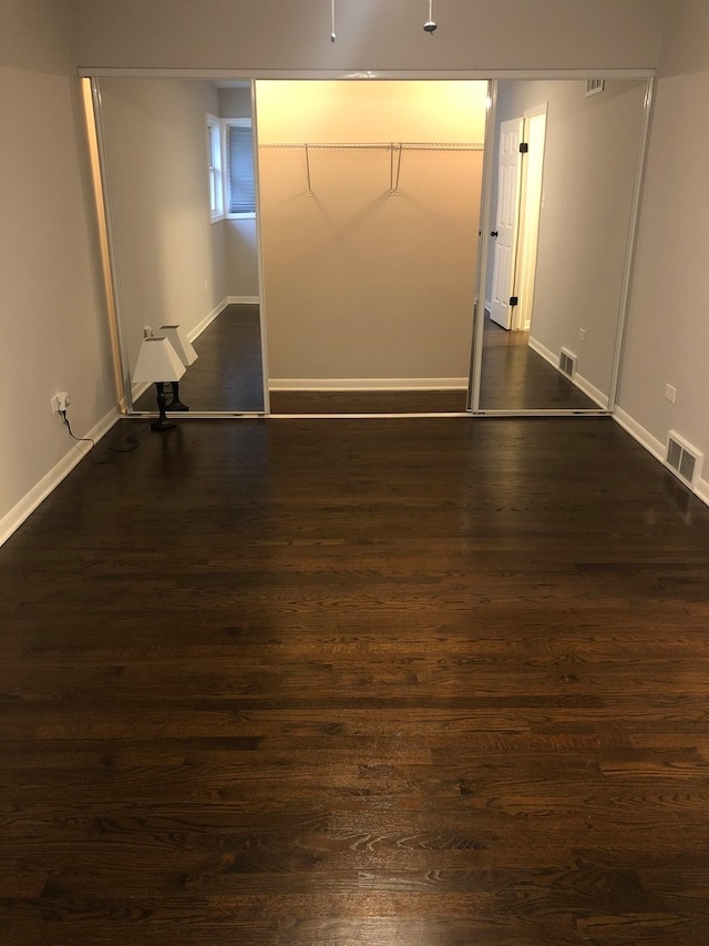 unfurnished room featuring dark hardwood / wood-style flooring