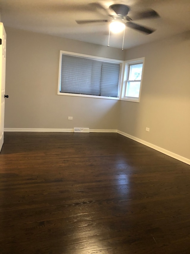 unfurnished room featuring dark hardwood / wood-style flooring and ceiling fan