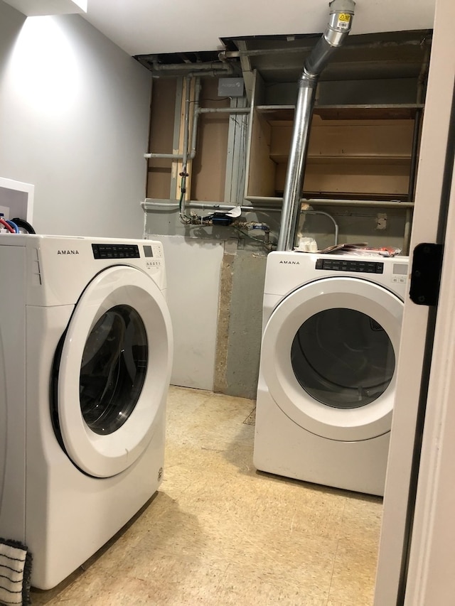 clothes washing area with light tile floors