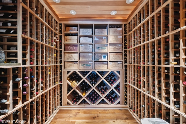 wine room featuring wooden ceiling and wood-type flooring