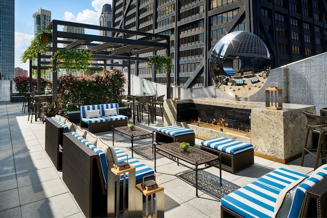 view of patio with an outdoor living space with a fireplace