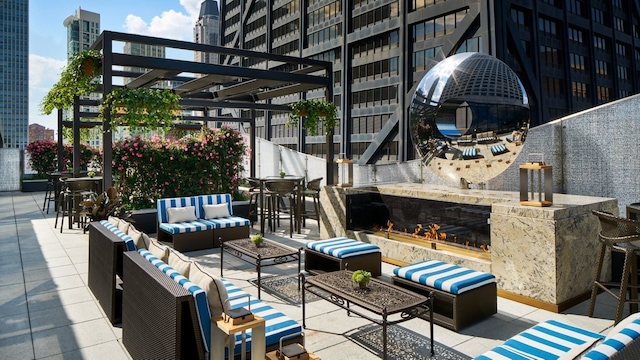 view of patio with an outdoor living space with a fireplace