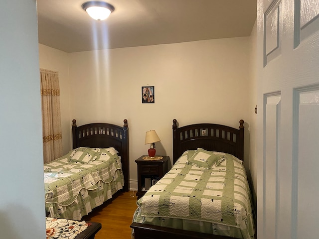 bedroom with dark hardwood / wood-style floors