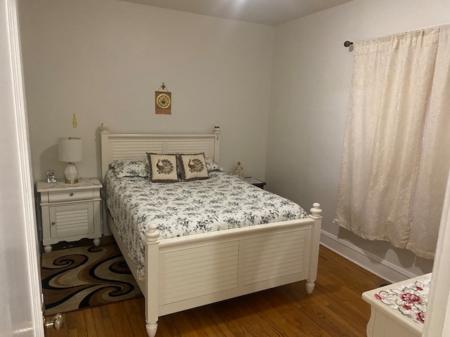 bedroom with dark wood-type flooring