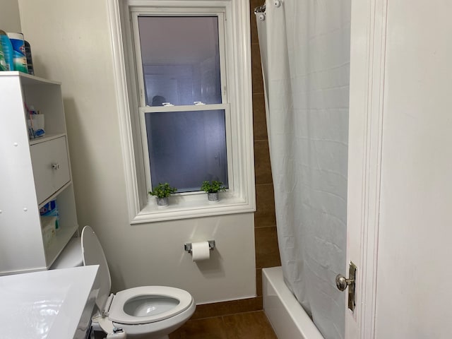 full bathroom featuring vanity, toilet, tile floors, and shower / bath combination with curtain