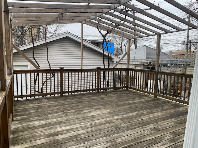 deck with a pergola and an outdoor structure