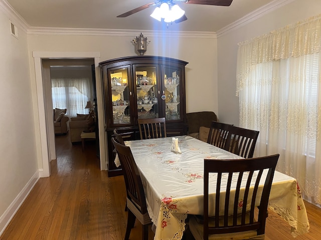 dining space featuring ornamental molding, dark hardwood / wood-style flooring, and ceiling fan