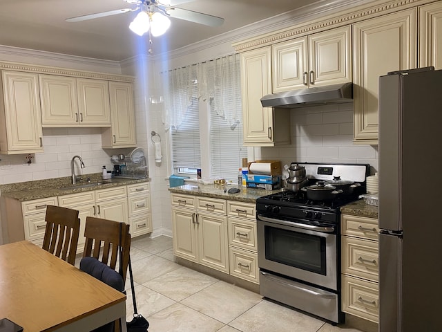 kitchen with appliances with stainless steel finishes, ceiling fan, crown molding, tasteful backsplash, and sink