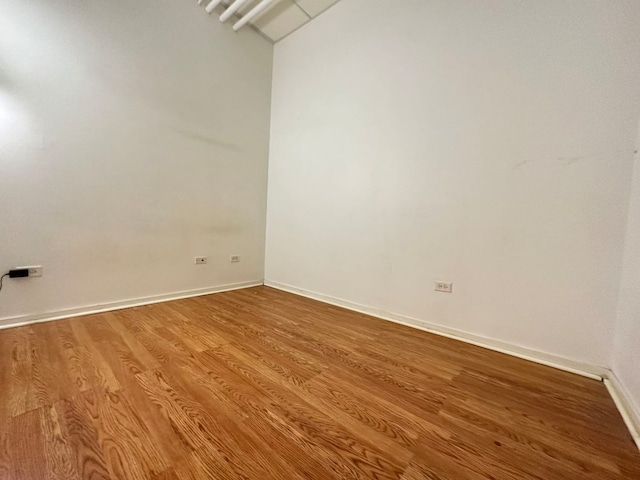 unfurnished room featuring hardwood / wood-style flooring