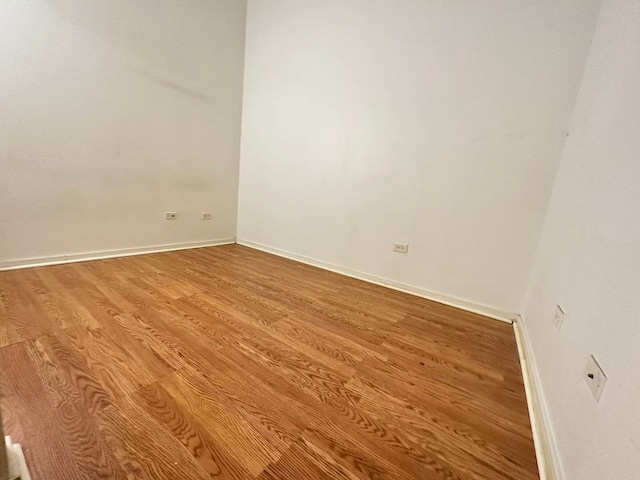 empty room with light hardwood / wood-style flooring