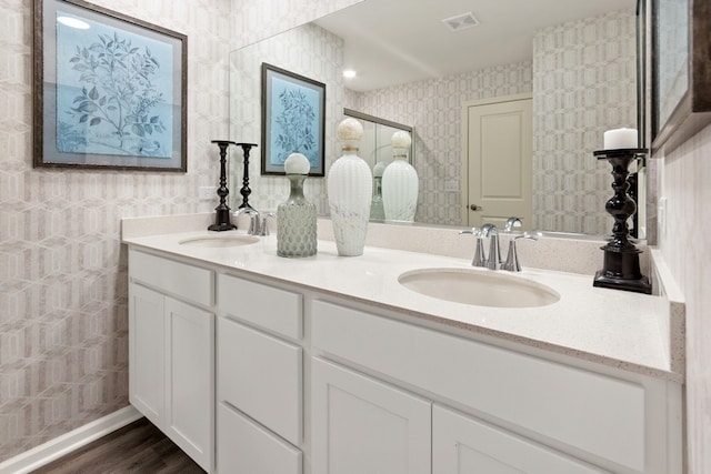 bathroom featuring double vanity and wood-type flooring