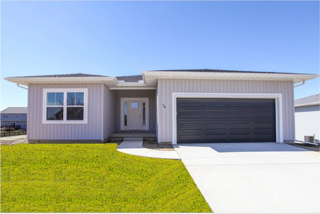 view of front of house with a garage, a front lawn, and central air condition unit