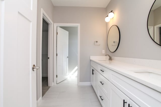 bathroom with double vanity and tile flooring