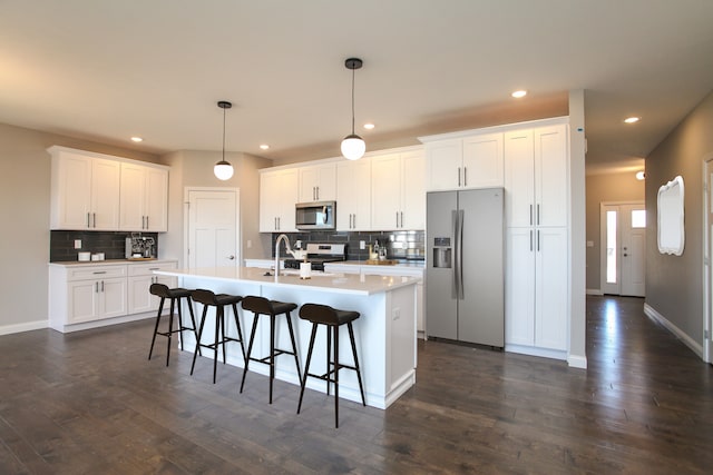 kitchen featuring white cabinetry, stainless steel appliances, and dark wood-type flooring