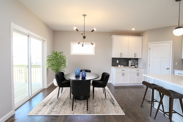 dining area featuring dark hardwood / wood-style flooring and a notable chandelier