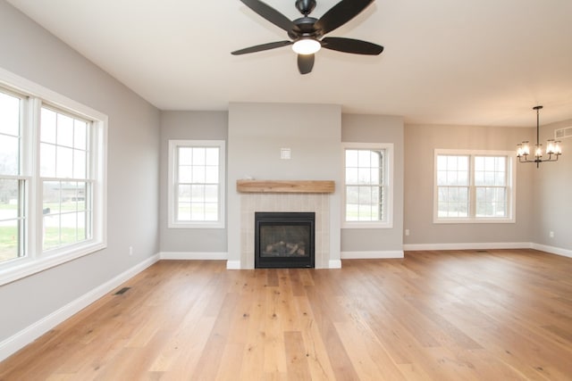 unfurnished living room with light wood-type flooring and a wealth of natural light