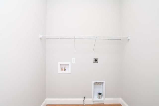 laundry area with electric dryer hookup, washer hookup, and light hardwood / wood-style floors