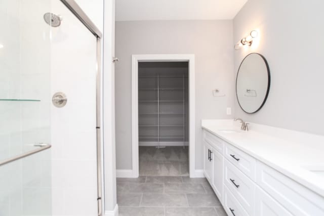 bathroom featuring walk in shower, tile floors, and vanity