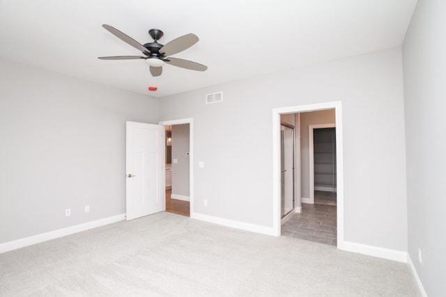 carpeted empty room with ceiling fan