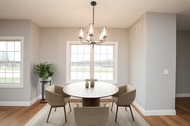 dining area featuring a notable chandelier and light hardwood / wood-style flooring