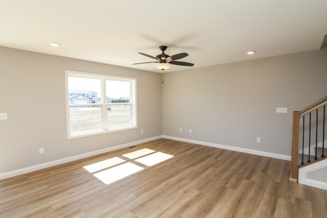 unfurnished room with hardwood / wood-style floors and ceiling fan