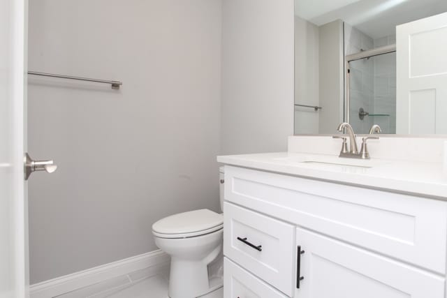 bathroom featuring oversized vanity, toilet, and tile flooring