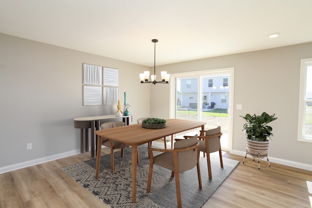 dining room featuring light hardwood / wood-style floors and an inviting chandelier