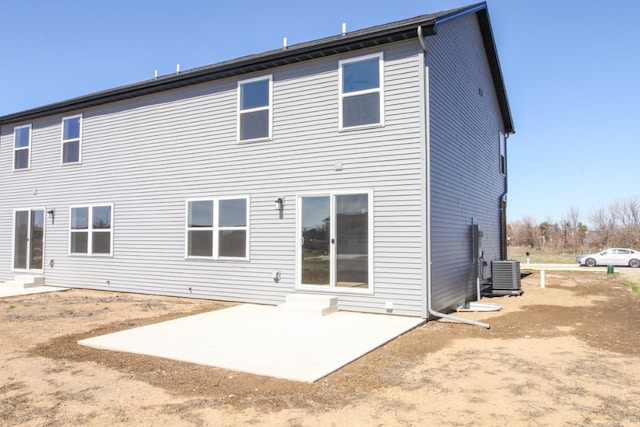 rear view of house featuring a patio and central air condition unit