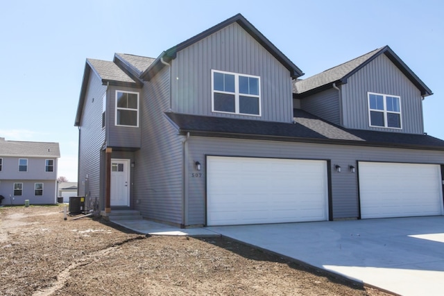 view of front of house featuring central AC unit and a garage