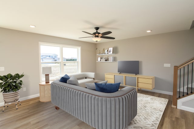 living room featuring ceiling fan and wood-type flooring