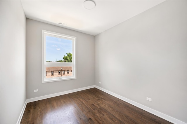 empty room featuring dark wood-type flooring