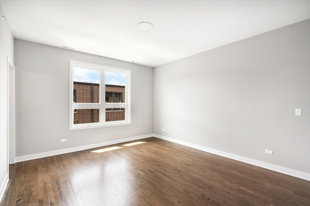 empty room with dark hardwood / wood-style floors