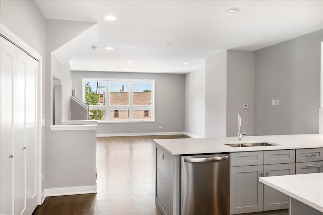 kitchen featuring dark hardwood / wood-style floors, sink, gray cabinets, and dishwasher