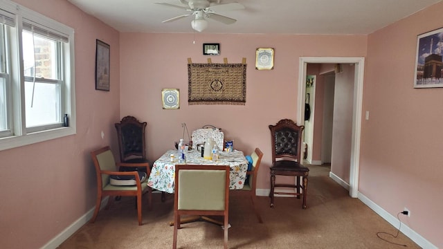 carpeted dining space featuring ceiling fan