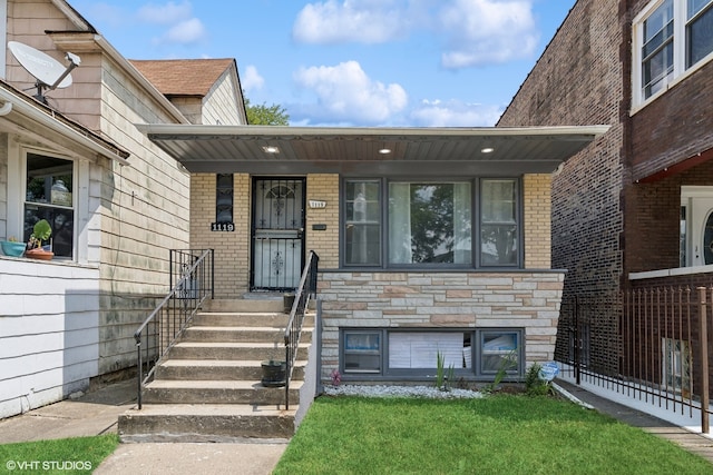 entrance to property with a yard