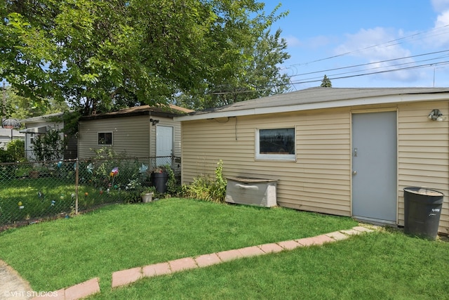 rear view of house featuring a yard