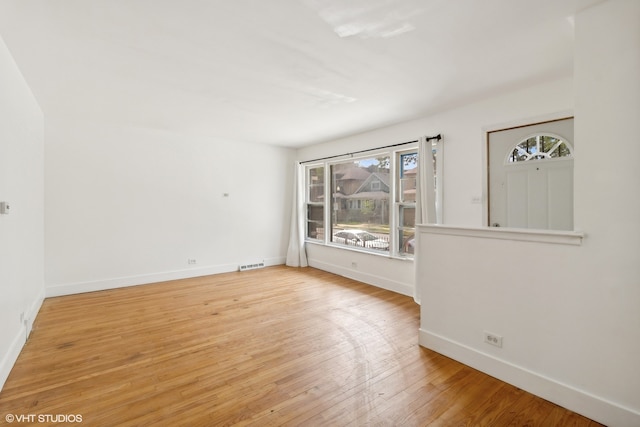 spare room featuring light hardwood / wood-style flooring