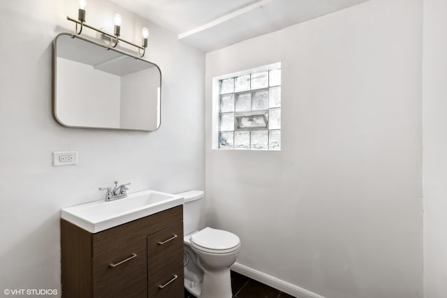 bathroom with vanity, toilet, and tile patterned flooring