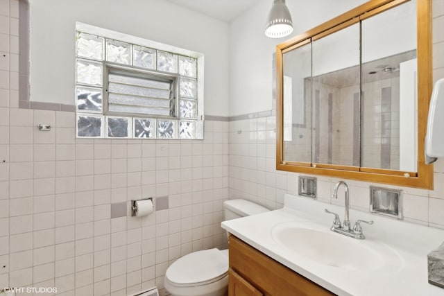 bathroom with tile walls, toilet, vanity, and decorative backsplash