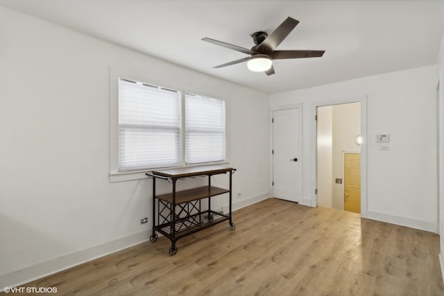 unfurnished room with ceiling fan and light wood-type flooring