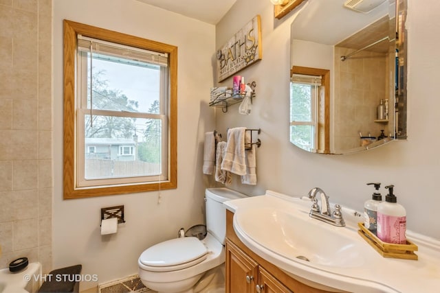 full bathroom with a shower, vanity, and toilet