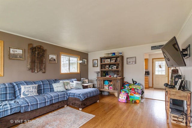 living room featuring ornamental molding and light wood-style floors