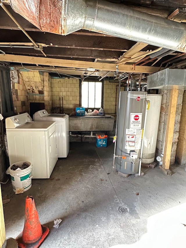 basement with water heater, separate washer and dryer, and sink